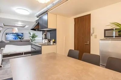 a kitchen and living room with a table and chairs at R301-Shinjuku 13 min Maximum 8 people 60 sqm Roppongi, Tsukiji direct access Full renovation 7 min walk from Ochiai Minami-Nagasaki Station in Tokyo