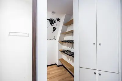 a walk in closet with white cabinets and wood floors at R301-Shinjuku 13 min Maximum 8 people 60 sqm Roppongi, Tsukiji direct access Full renovation 7 min walk from Ochiai Minami-Nagasaki Station in Tokyo