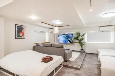 a living room with a bed and a couch at R301-Shinjuku 13 min Maximum 8 people 60 sqm Roppongi, Tsukiji direct access Full renovation 7 min walk from Ochiai Minami-Nagasaki Station in Tokyo