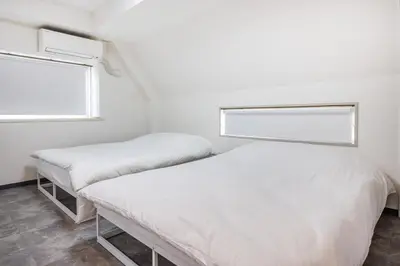 two beds in a small room with a window at R301-Shinjuku 13 min Maximum 8 people 60 sqm Roppongi, Tsukiji direct access Full renovation 7 min walk from Ochiai Minami-Nagasaki Station in Tokyo