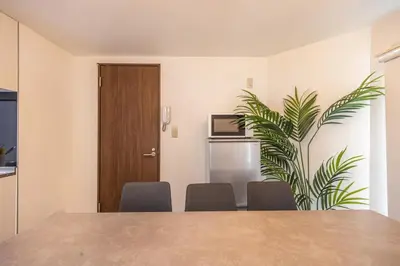a dining room with a table and a plant at R301-Shinjuku 13 min Maximum 8 people 60 sqm Roppongi, Tsukiji direct access Full renovation 7 min walk from Ochiai Minami-Nagasaki Station in Tokyo