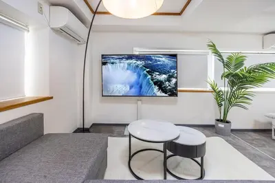a living room with a table and a tv on the wall at R301-Shinjuku 13 min Maximum 8 people 60 sqm Roppongi, Tsukiji direct access Full renovation 7 min walk from Ochiai Minami-Nagasaki Station in Tokyo