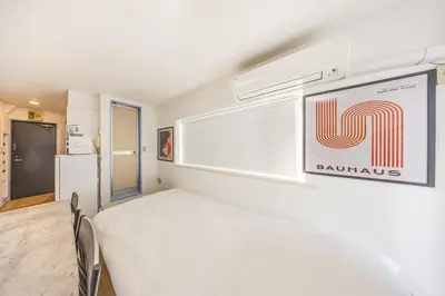 a room with a bed and a sign on the wall at R401-Shinjuku 13 minutes Maximum 4 people 30 square meters Full renovation Roppongi and Tsukiji direct access Family group best 7 minutes from Ochiai Minami-Nagasaki Station in Tokyo