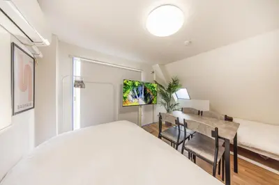 a bedroom with a bed and a table and chairs at R401-Shinjuku 13 minutes Maximum 4 people 30 square meters Full renovation Roppongi and Tsukiji direct access Family group best 7 minutes from Ochiai Minami-Nagasaki Station in Tokyo
