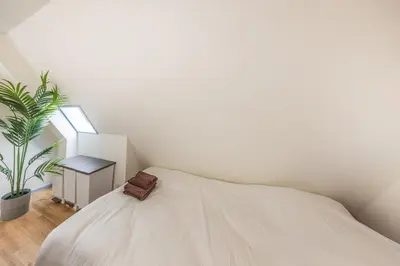 a white bedroom with a bed and a plant at R401-Shinjuku 13 minutes Maximum 4 people 30 square meters Full renovation Roppongi and Tsukiji direct access Family group best 7 minutes from Ochiai Minami-Nagasaki Station in Tokyo