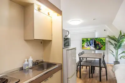 a small kitchen with a sink and a table at R401-Shinjuku 13 minutes Maximum 4 people 30 square meters Full renovation Roppongi and Tsukiji direct access Family group best 7 minutes from Ochiai Minami-Nagasaki Station in Tokyo