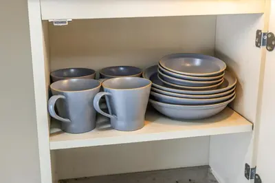 a group of cups and plates in a cupboard at R401-Shinjuku 13 minutes Maximum 4 people 30 square meters Full renovation Roppongi and Tsukiji direct access Family group best 7 minutes from Ochiai Minami-Nagasaki Station in Tokyo