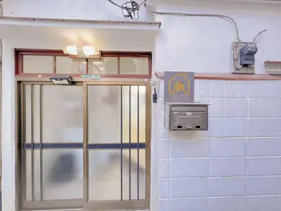 a door to a building with a sign on it at \u53cb\u7e01\u306e\u5bb6Destined Bonds Haven\u897f\u5de3\u9d28 in Tokyo