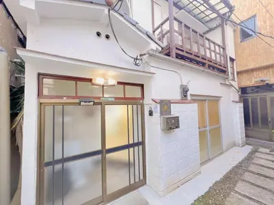 a building with a large door and a balcony at \u53cb\u7e01\u306e\u5bb6Destined Bonds Haven\u897f\u5de3\u9d28 in Tokyo