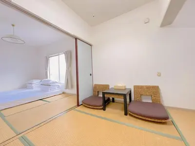 a room with a table and two chairs and a bed at \u53cb\u7e01\u306e\u5bb6Destined Bonds Haven\u897f\u5de3\u9d28 in Tokyo
