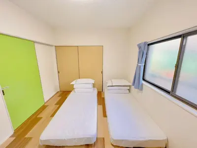 a hospital room with three beds and a window at \u53cb\u7e01\u306e\u5bb6Destined Bonds Haven\u897f\u5de3\u9d28 in Tokyo