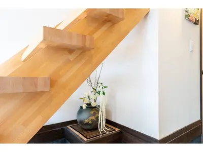 a wooden staircase with a vase on a table at YADOYA Ryusenjicho - Vacation STAY 86915v in Tokyo