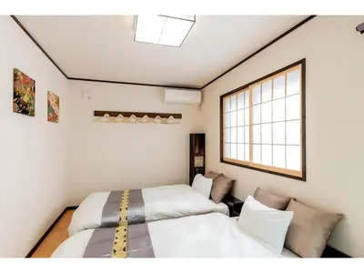 two beds in a room with a window at YADOYA Ryusenjicho - Vacation STAY 86915v in Tokyo