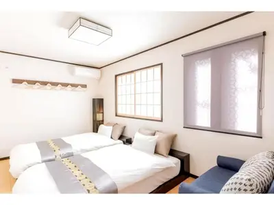 a bedroom with two beds and a couch at YADOYA Ryusenjicho - Vacation STAY 86915v in Tokyo
