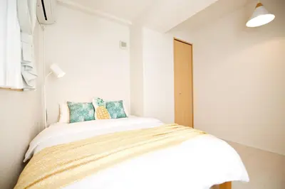 a bedroom with a bed in a white room at Regalia Hills Shibuya Dogenzaka - Vacation STAY 18960 in Tokyo