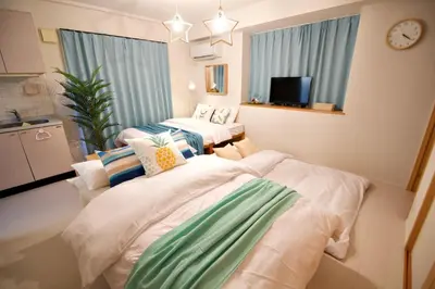 a room with two beds and a tv in it at Regalia Hills Shibuya Dogenzaka - Vacation STAY 18960 in Tokyo