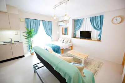 a living room with a couch and a bed at Regalia Hills Shibuya Dogenzaka - Vacation STAY 18960 in Tokyo