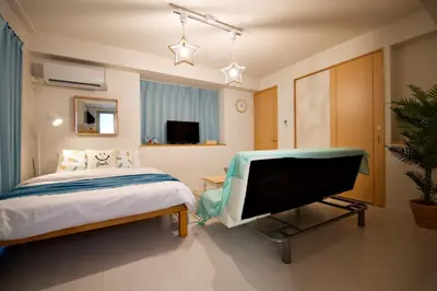 a bedroom with a bed and a flat screen tv at Regalia Hills Shibuya Dogenzaka - Vacation STAY 18960 in Tokyo