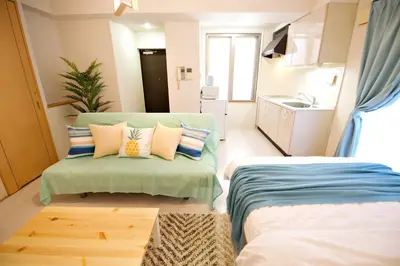 a living room with two beds and a couch at Regalia Hills Shibuya Dogenzaka - Vacation STAY 18960 in Tokyo