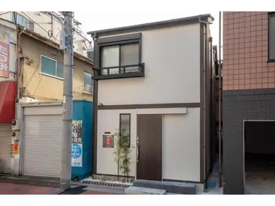 a white building with a door on a street at YADOYA Matsugaya - Vacation STAY 91980v in Tokyo