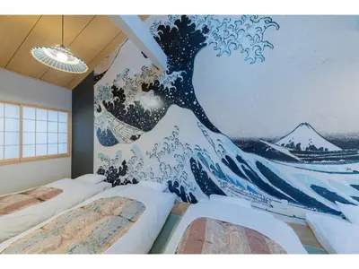 a bedroom with two beds with a mural of a wave at YADOYA Negishi - Vacation STAY 92008v in Tokyo
