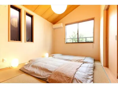 a large bed in a room with two windows at YADOYA Asakusa-Honkan - Vacation STAY 92044v in Tokyo