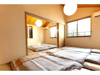 two beds in a room with a mirror at YADOYA Asakusa-Honkan - Vacation STAY 92044v in Tokyo