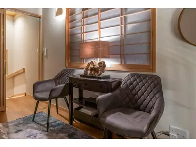 a room with a table with two chairs and a lamp at YADOYA Yanagitori West - Vacation STAY 92053v in Tokyo