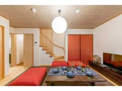 a living room with a red couch and a table at YADOYA Yanagitori East - Vacation STAY 92067v in Tokyo