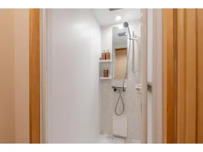 a bathroom with a shower with a sink and a mirror at YADOYA Yanagitori East - Vacation STAY 92067v in Tokyo