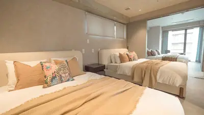 a bedroom with two beds and a window at LANG HOTEL Asakusa#Senso-ji Temple#1Floor 1Room 85m2# Max 8ppl in Tokyo