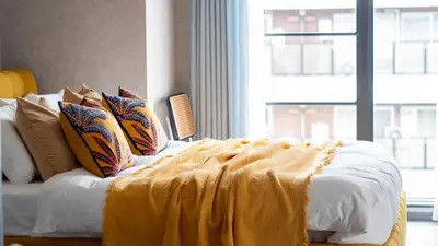 a bed with a yellow blanket on it with a window at LANG HOTEL Asakusa#Senso-ji Temple#1Floor 1Room 85m2# Max 8ppl in Tokyo