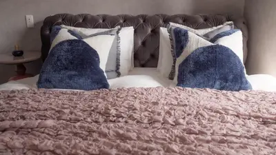 a bed with a pink blanket and pillows on it at LANG HOTEL Asakusa#Senso-ji Temple#1Floor 1Room 85m2# Max 8ppl in Tokyo