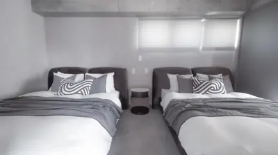 two beds sitting next to each other in a bedroom at LANG HOTEL Asakusa#Senso-ji Temple#1Floor 1Room 85m2# Max 8ppl in Tokyo