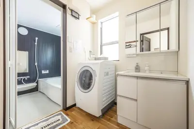 a bathroom with a washing machine and a sink at Nogata Station 3 minutes on foot , 15 minutes to Shinjuku in Tokyo