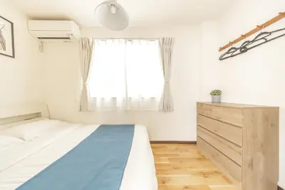a bedroom with a bed and a window at Nogata Station 3 minutes on foot , 15 minutes to Shinjuku in Tokyo