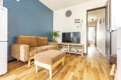 a living room with a couch and a tv at Nogata Station 3 minutes on foot , 15 minutes to Shinjuku in Tokyo