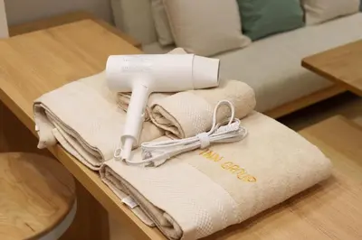 a pile of towels on a table next to a bed at \u5922\u306e\u5bbf \u7a42\u7a7a 123t in Tokyo