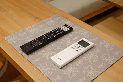 a remote control and a thermometer on a table at \u5922\u306e\u5bbf \u7a42\u7a7a 123t in Tokyo
