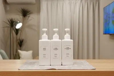 three white bottles ofodorizers sitting on top of a table at \u5922\u306e\u5bbf \u7a42\u7a7a 123t in Tokyo