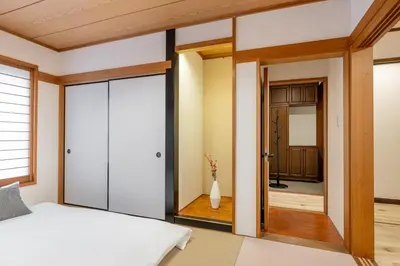 a bedroom with a bed and a mirror at Shibuya-honmachi 2-3f in Tokyo