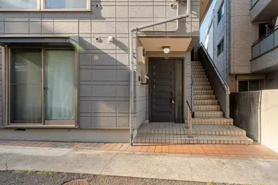 a stairway leading to a door in a building at Shibuya-honmachi 2-3f in Tokyo