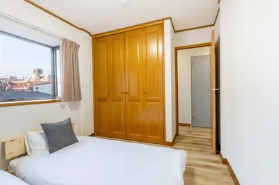 a small bedroom with a bed and a window at Shibuya-honmachi 2-3f in Tokyo