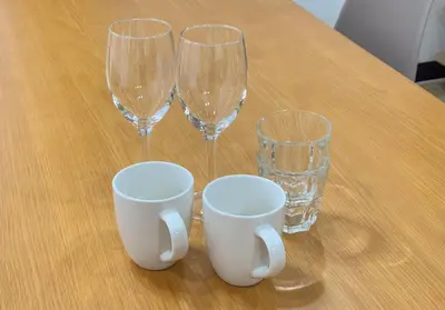 three wine glasses and two cups on a table at Shibuya-honmachi 2-3f in Tokyo