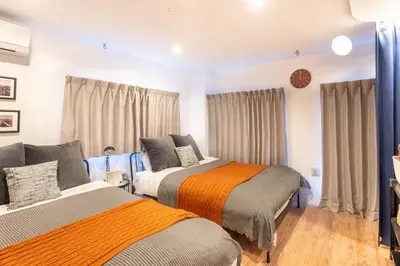 two beds in a room with curtains at \u5922\u306e\u5bbf \u97ff 125t in Tokyo