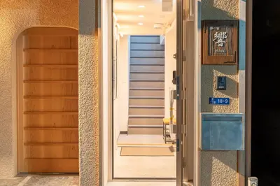 a door leading to a hallway with stairs at \u5922\u306e\u5bbf \u97ff 125t in Tokyo