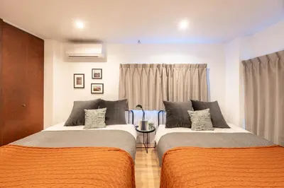 two beds sitting next to each other in a room at \u5922\u306e\u5bbf \u97ff 125t in Tokyo