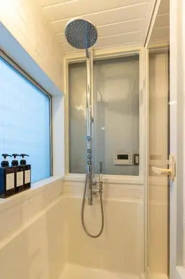 a shower in a bathroom with a window at \u5922\u306e\u5bbf \u97ff 125t in Tokyo