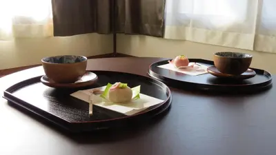 two plates and two cups on a table with food at Y's INN Oyama 021T in Tokyo