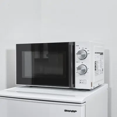 a microwave sitting on top of a white cabinet at Y's INN Oyama 021T in Tokyo
